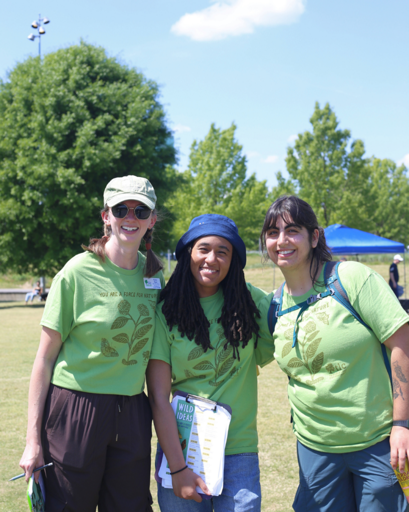 TLC's Education and Outreach team, Kayla Ebert, Amaya Horner, and Meera Butalia, smile for a photo at Wild Ideas.