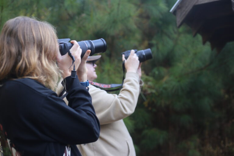 Two nature photography event attendees taking photos